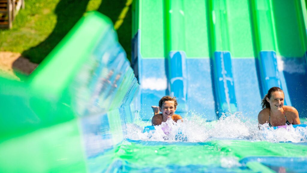 A boy and girl splashing down waterslides in Wisconsin Dells
