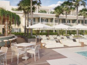 A rendering of the pool area with loungers and umbrellas and an outdoor bar at The Cooper