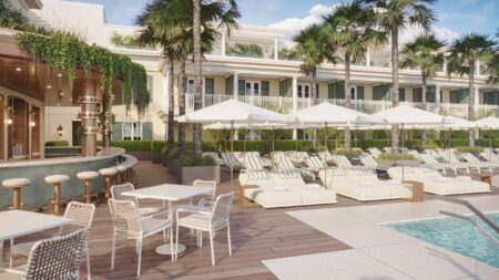 A rendering of the pool area with loungers and umbrellas and an outdoor bar at The Cooper
