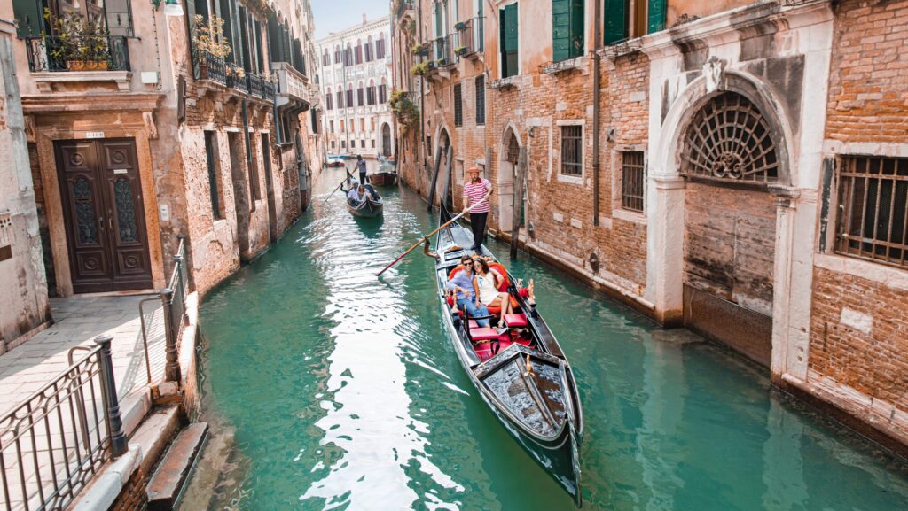 Pasangan mengendarai gondola di Venesia