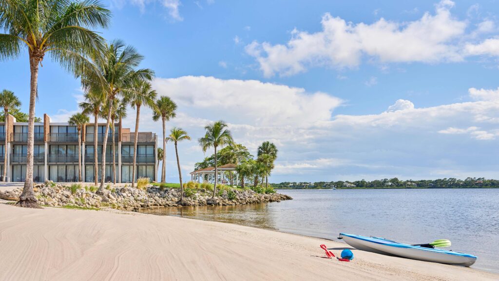 A kayak on sand by the water at voco Sandpiper All-Inclusive Resort