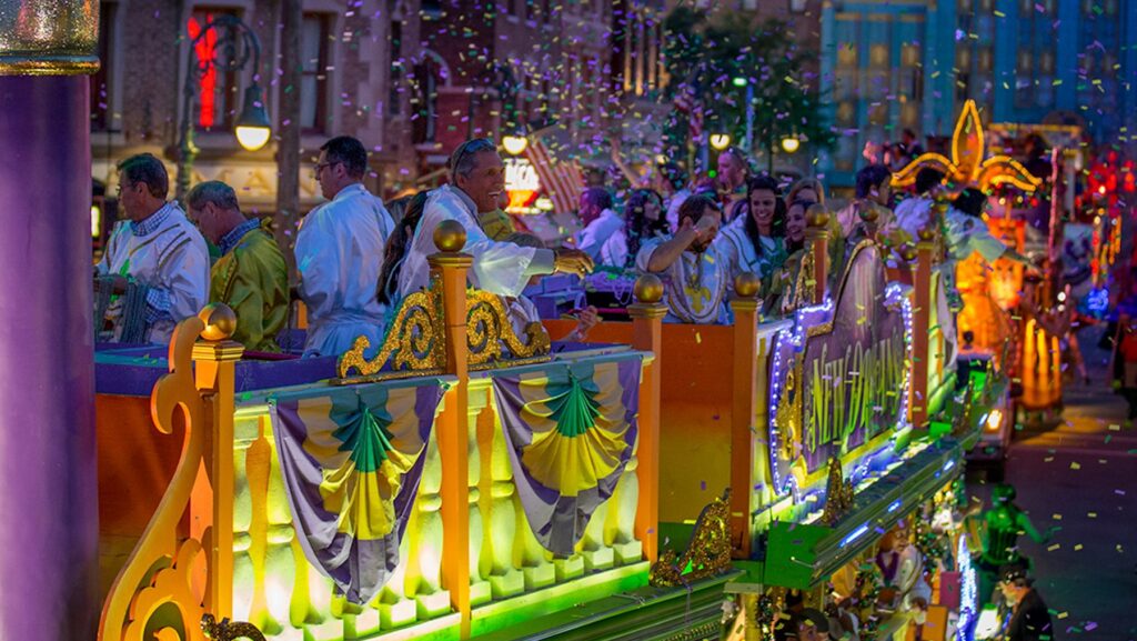 People riding a Mardi Gras parade float at Universal Orlando
