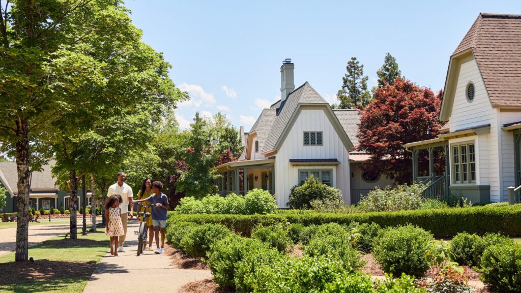 A family walking on a path with a bike at Barnsley Resort