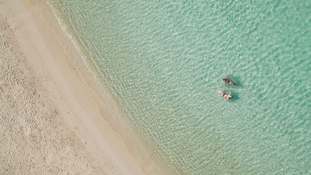Two women floating in the water at Eagle Beach on Aruba