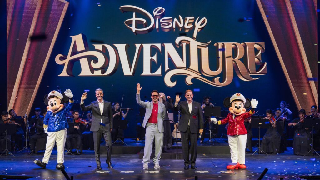 Robert Downey, Jr., Josh D'Amaro, Joe Schott, Mickey Mouse, and Minnie Mouse on stage at the christening ceremony of the Disney Adventure