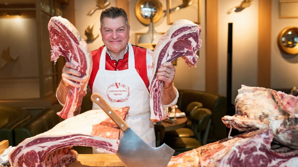 Man holding blocks of steaks
