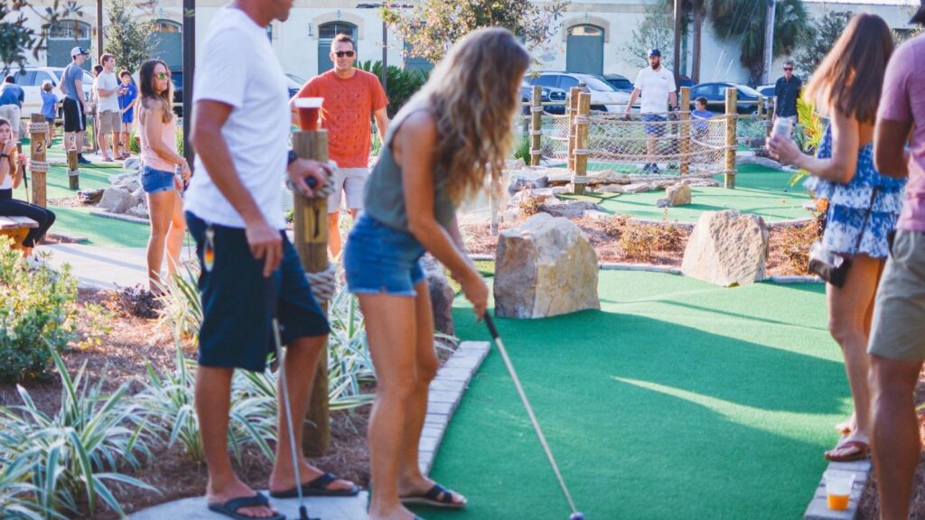 Teenagers and adults play mini golf on Amelia Island in Florida