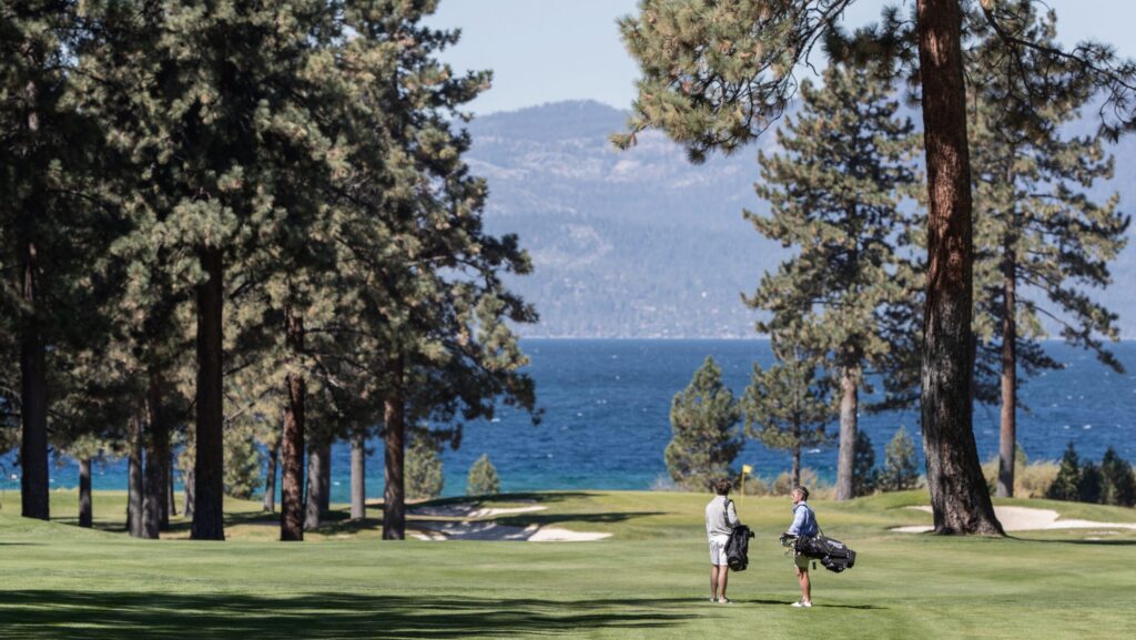 Two men golfing with a view of Lake Tahoe