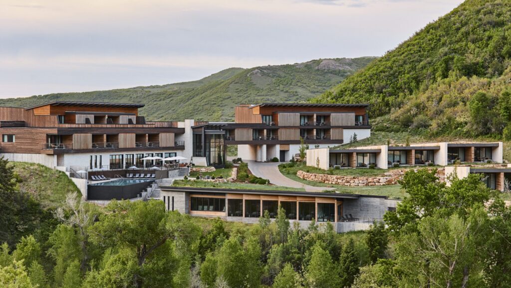 Hotel set against the green foothills of Utah.