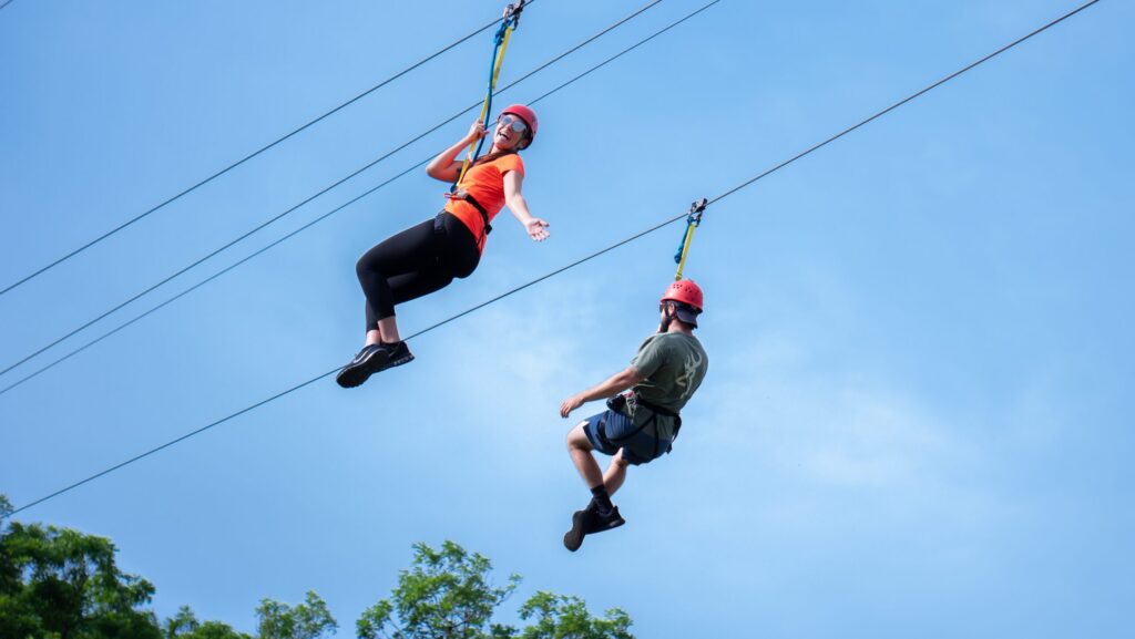 Two people zip lining