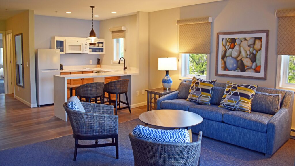 The living room and kitchen area of a unit in The Villages secion of Ocean Edge Resort