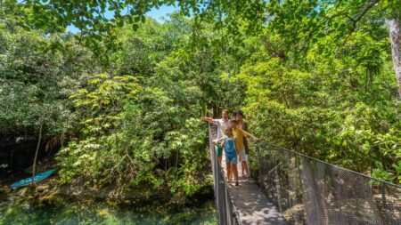 A family on a rope bridge at Sandos Caracol Nature Resort