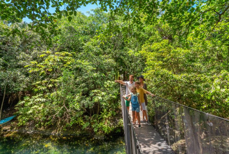 A family on a rope bridge at Sandos Caracol Nature Resort