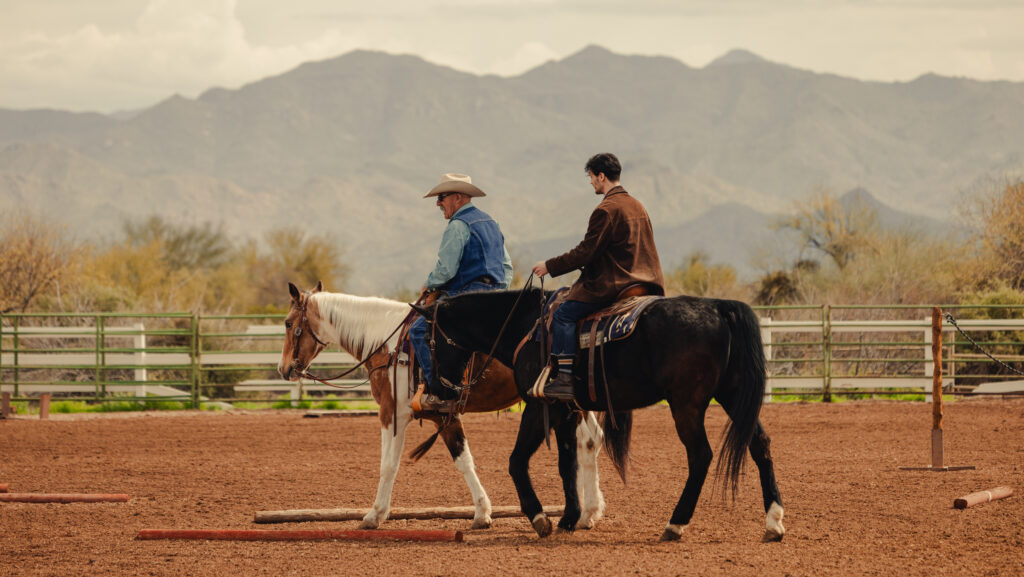 Two men riding horses