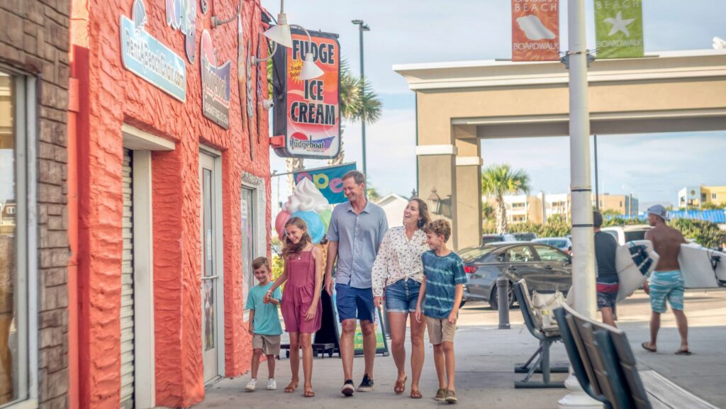 A family walking in downtown Carolina Beach