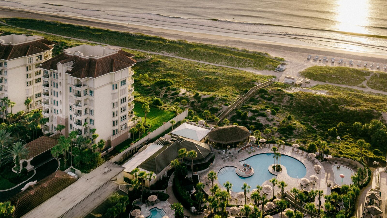 An aerial view at sunset of The Ritz-Carlton, Amelia Island and its beach