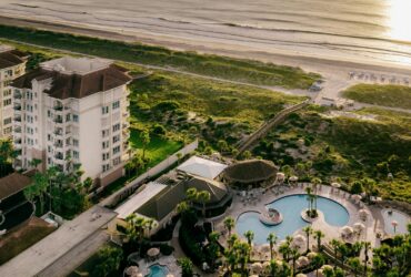 An aerial view at sunset of The Ritz-Carlton, Amelia Island and its beach