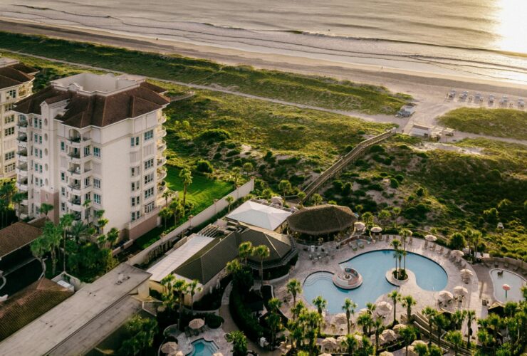 An aerial view at sunset of The Ritz-Carlton, Amelia Island and its beach