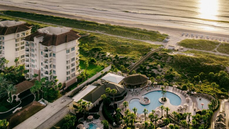 An aerial view at sunset of The Ritz-Carlton, Amelia Island and its beach