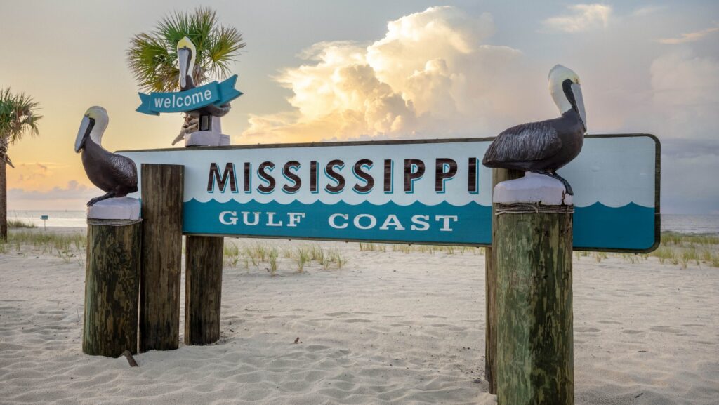 A Mississippi beach sign at sunset