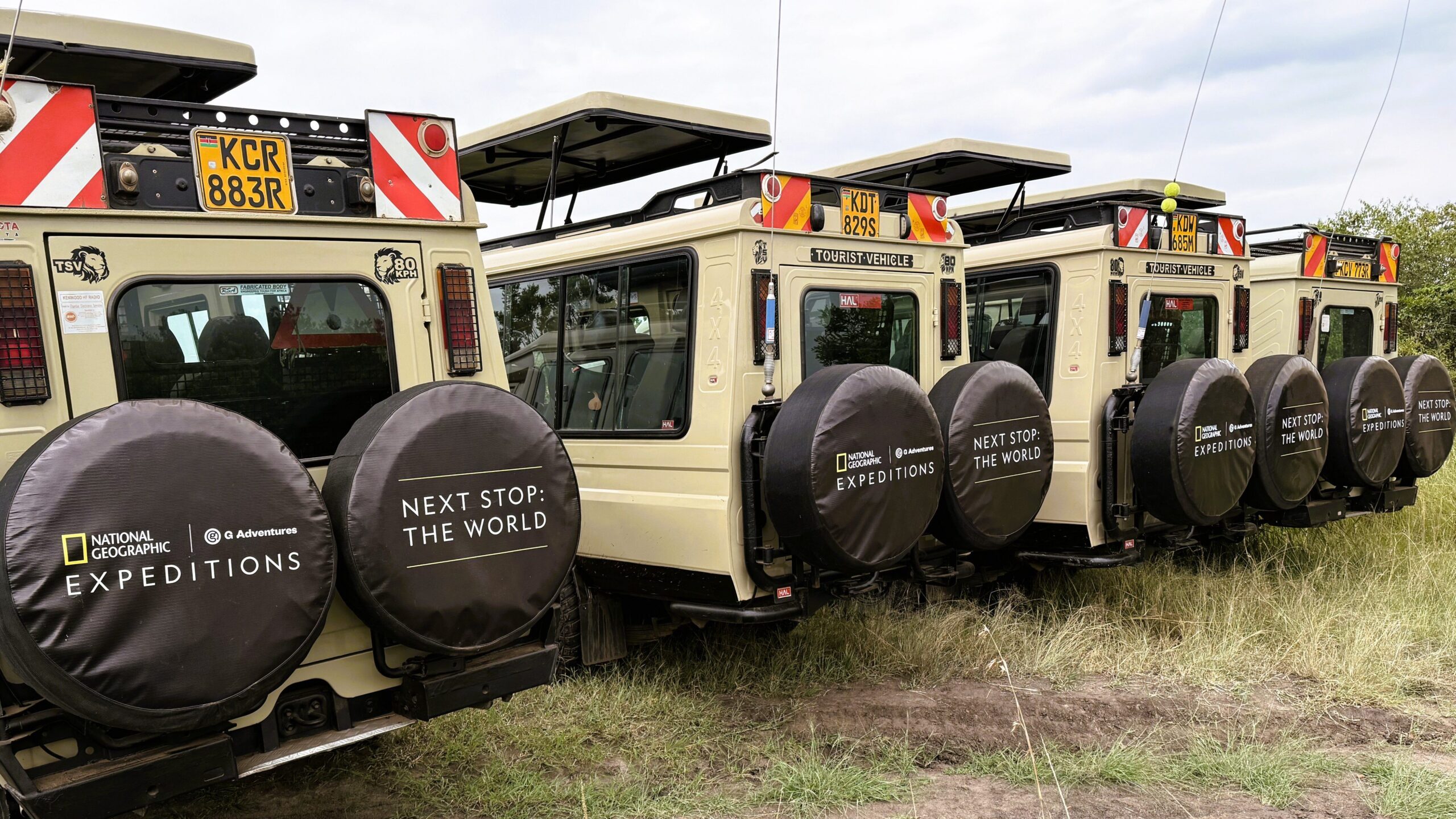 Four National Geographic Expedition safari vehicles line up in Africa