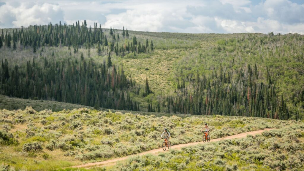 Teens riding mountain bikes at Brush Creek Ranch