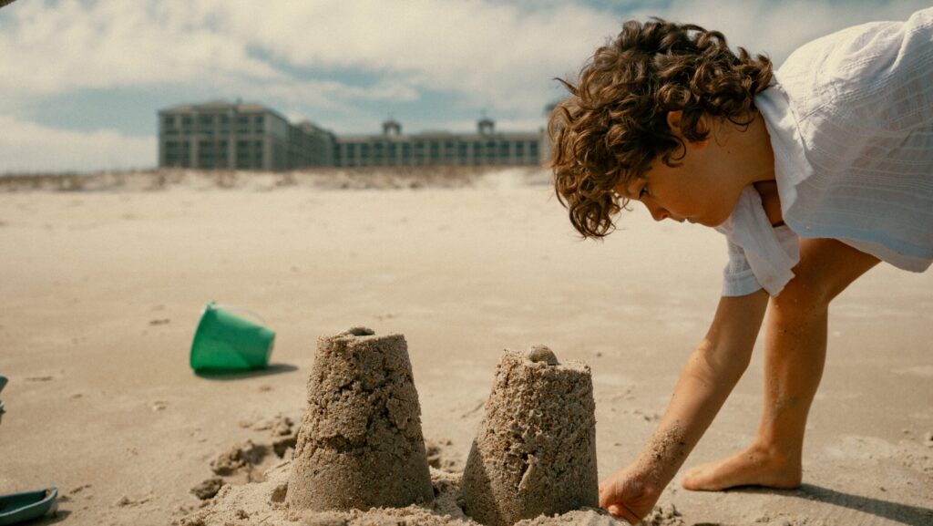 A little kid building sandcastles on the beach at The Ritz-Carlton, Amelia Island