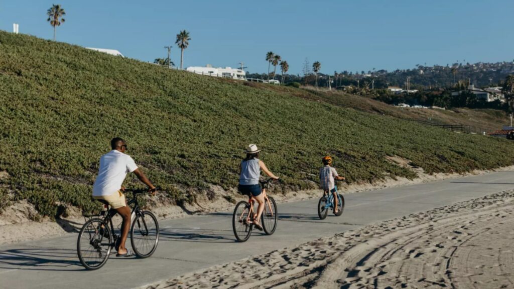 A family riding bikes on The Strand in Torrance