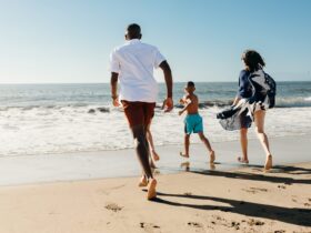 A family running toward the water's edge in Torrance, CA