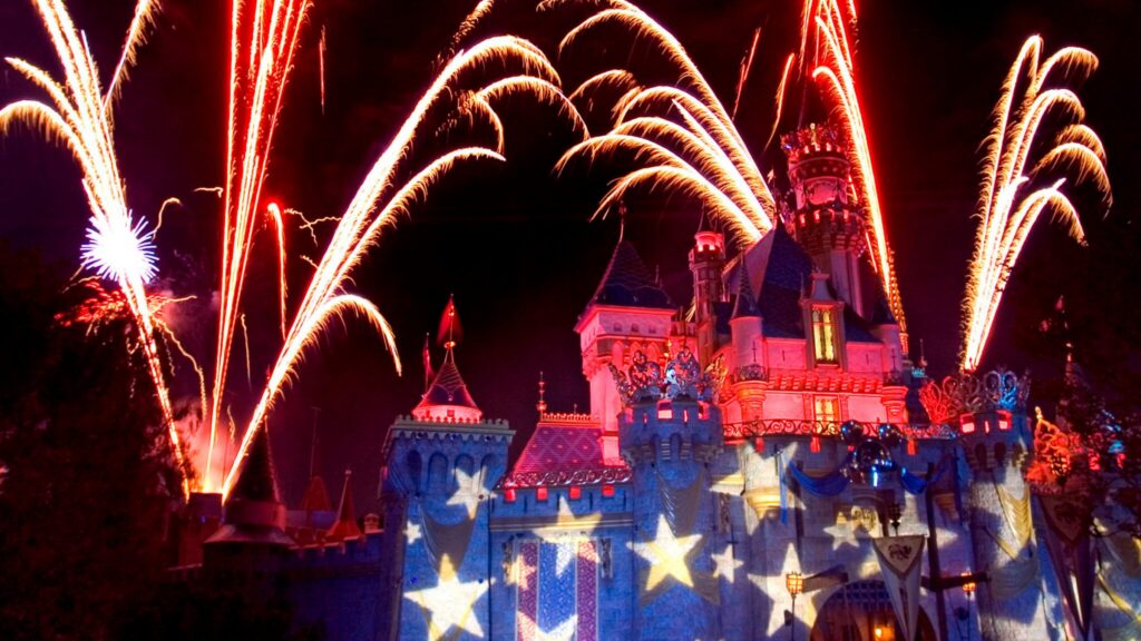 Fireworks going off over Sleeping Beauty Castle.
