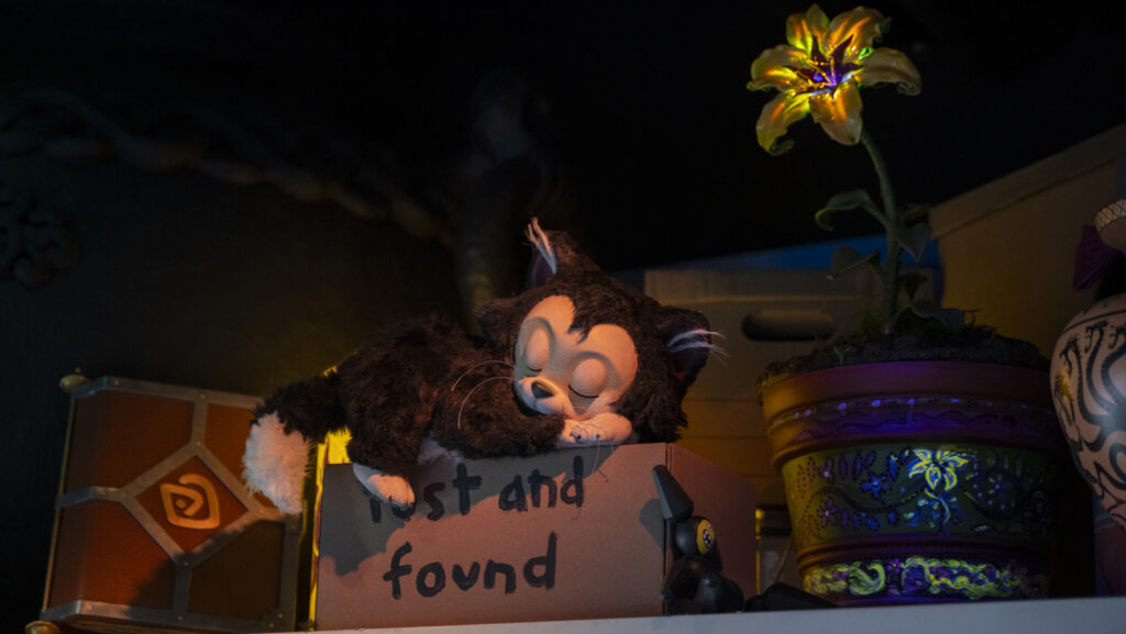 Sleeping cat among Disney relics.